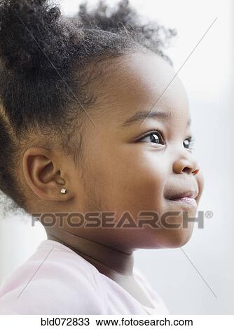 Stock Image - Close up of smiling African American girl. Fotosearch