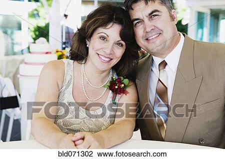 Stock Image - Couple hugging at wedding. Fotosearch
