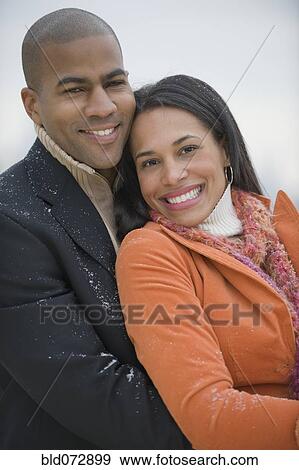 Couple hugging in snow View Large Photo Image Stock Photo - Couple hugging in snow. Fotosearch