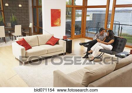 Picture - Couple relaxing in livingroom. Fotosearch