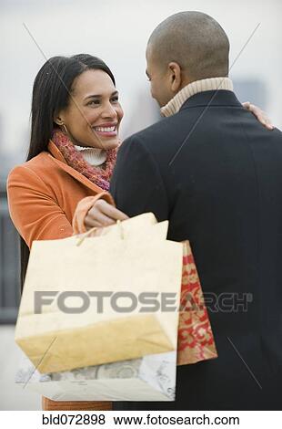 Stock Photo - Couple with shopping bags. Fotosearch