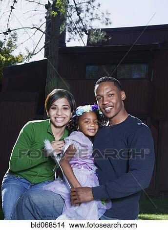 Picture - Daughter in costume with parents. Fotosearch