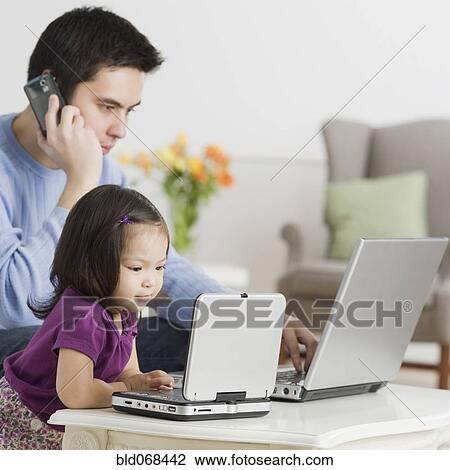 Father and daughter using laptops View Large Photo Image Stock Image - Father and daughter using laptops. Fotosearch