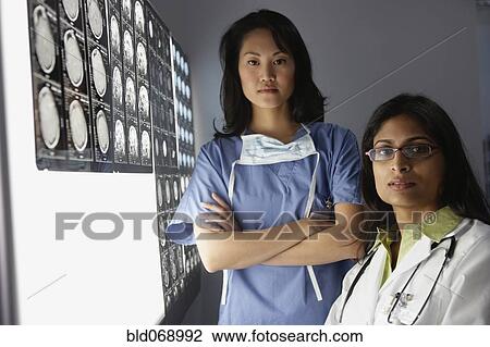 Female doctors next to x-rays View Large Photo Image Stock Image - Female doctors next to x-rays. Fotosearch
