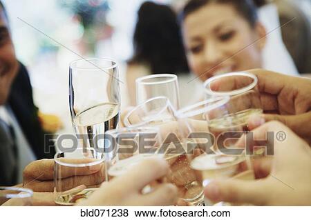 Stock Photo - Friends toasting with champagne. Fotosearch