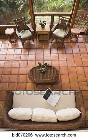 Stock Photograph - High angle view of empty livingroom with laptop on sofa. Fotosearch