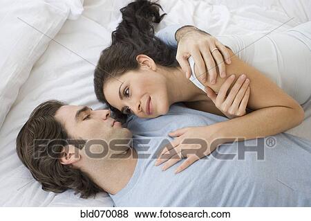 High angle view of Hispanic couple hugging in bed View Large Photo Image Stock Photo - High angle view of Hispanic couple hugging in bed. Fotosearch