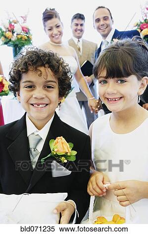Stock Photography - Hispanic boy and girl as ring bearer and flower girl. Fotosearch