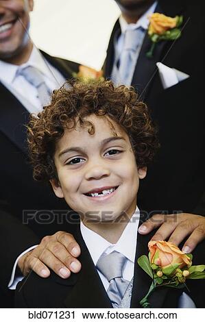 Stock Image - Hispanic boy wearing tuxedo. Fotosearch