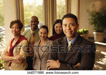 Hispanic businessman in front of coworkers View Large Photo Image Stock Photograph - Hispanic businessman in front of coworkers. Fotosearch