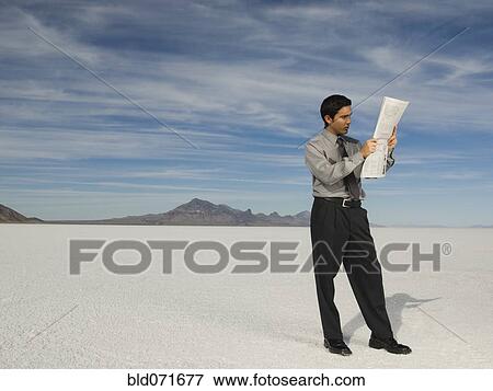 Stock Photo - Hispanic businessman reading newspaper. Fotosearch