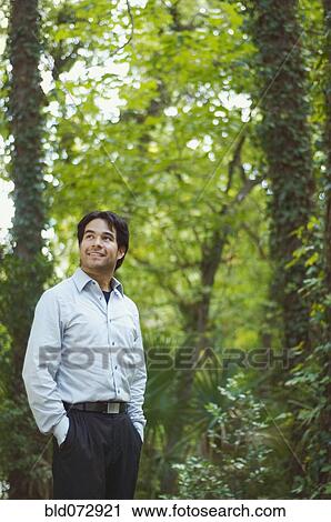 Hispanic businessman standing in woods View Large Photo Image Stock Image - Hispanic businessman standing in woods. Fotosearch