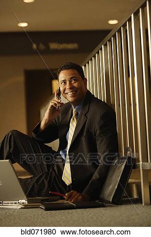 Hispanic businessman talking on cell phone View Large Photo Image Stock Image - Hispanic businessman talking on cell phone. Fotosearch