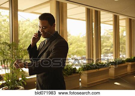 Hispanic businessman talking on cell phone View Large Photo Image Stock Image - Hispanic businessman talking on cell phone. Fotosearch