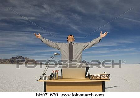 Stock Image - Hispanic businessman with arms raised. Fotosearch