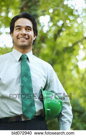 Hispanic businessman with green hard hat View Large Photo Image Stock Image - Hispanic businessman with green hard hat. Fotosearch