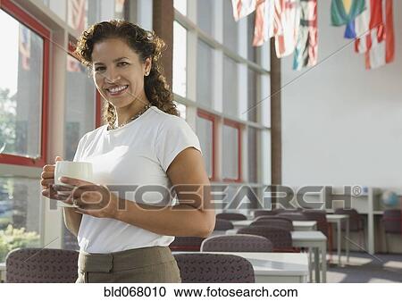 Hispanic businesswoman holding coffee cup View Large Photo Image Stock Image - Hispanic businesswoman holding coffee cup. Fotosearch