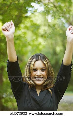 Hispanic businesswoman posing with arms raised View Large Photo Image Stock Image - Hispanic businesswoman posing with arms raised. Fotosearch