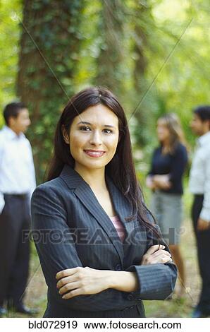Stock Photo - Hispanic businesswoman posing with arms crossed. Fotosearch