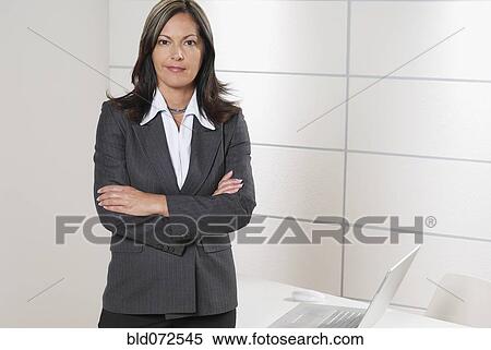 Hispanic businesswoman with arms crossed View Large Photo Image Stock Photography - Hispanic businesswoman with arms crossed. Fotosearch