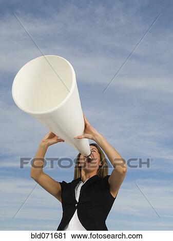 Hispanic businesswoman yelling into megaphone View Large Photo Image Stock Image - Hispanic businesswoman yelling into megaphone. Fotosearch