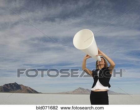 Hispanic businesswoman yelling into megaphone View Large Photo Image Stock Image - Hispanic businesswoman yelling into megaphone. Fotosearch