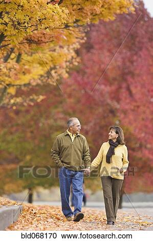 Hispanic couple holding hands outdoors in autumn View Large Photo Image Stock Image - Hispanic couple holding hands outdoors in autumn. Fotosearch
