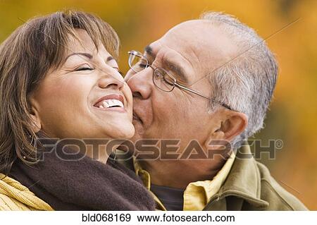 Stock Photo - Hispanic couple kissing outdoors. Fotosearch