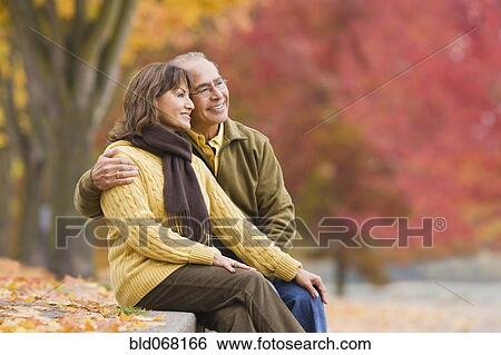Hispanic couple sitting outdoors in autumn View Large Photo Image Stock Photograph - Hispanic couple sitting outdoors in autumn. Fotosearch