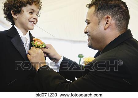 Hispanic father fastening boutonniere for son View Large Photo Image Stock Image - Hispanic father fastening boutonniere for son. Fotosearch