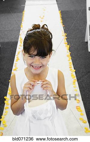 Stock Photograph - Hispanic flower girl at wedding. Fotosearch