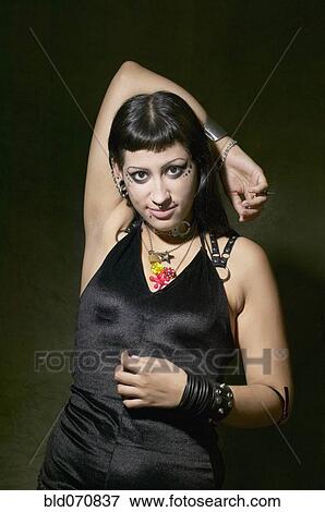 Hispanic Goth woman with arm behind head View Large Photo Image Stock Photo - Hispanic Goth woman with arm behind head. Fotosearch