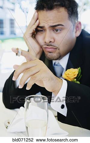 Stock Image - Hispanic groom looking sad. Fotosearch