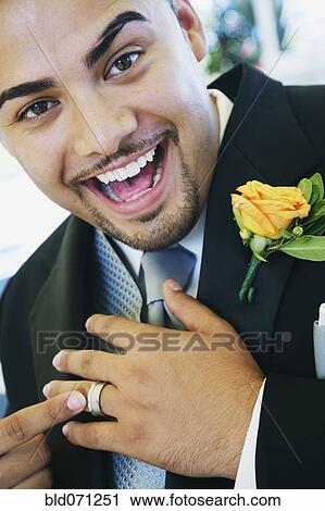 Stock Image - Hispanic groom showing ring. Fotosearch