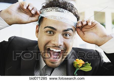 Hispanic groom wearing garter on head View Large Photo Image Stock Photography - Hispanic groom wearing garter on head. Fotosearch