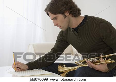 Hispanic man composing trumpet music View Large Photo Image Stock Photo - Hispanic man composing trumpet music. Fotosearch