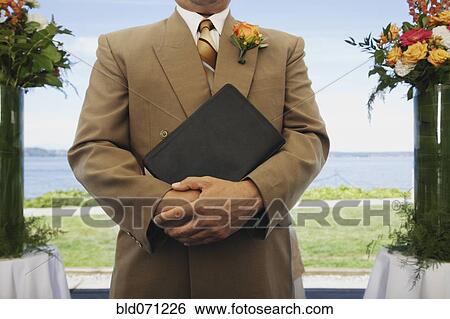 Hispanic man holding book View Large Photo Image Stock Photograph - Hispanic man holding book. Fotosearch