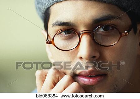 Picture - Hispanic man wearing eyeglasses and hat. Fotosearch