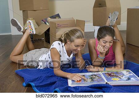 Hispanic teenage girls looking at photograph album View Large Photo Image Stock Photography - Hispanic teenage girls looking at photograph album. Fotosearch