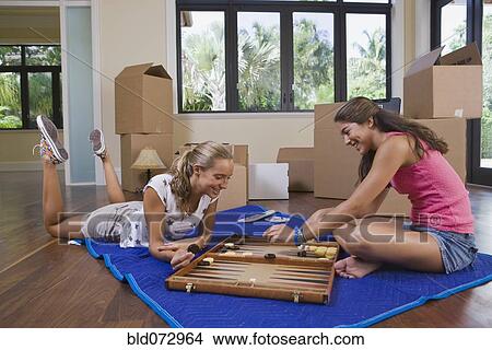 Picture - Hispanic teenage girls playing backgammon. Fotosearch