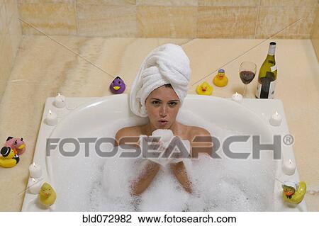 Hispanic woman holding bubbles in bathtub View Large Photo Image Stock Image - Hispanic woman holding bubbles in bathtub. Fotosearch
