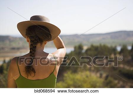 Hispanic woman in hat viewing remote landscape View Large Photo Image Picture - Hispanic woman in hat viewing remote landscape. Fotosearch