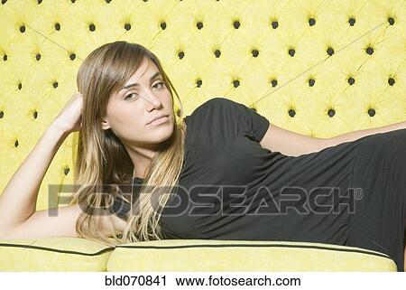 Hispanic woman laying on sofa View Large Photo Image Stock Image - Hispanic woman laying on sofa. Fotosearch