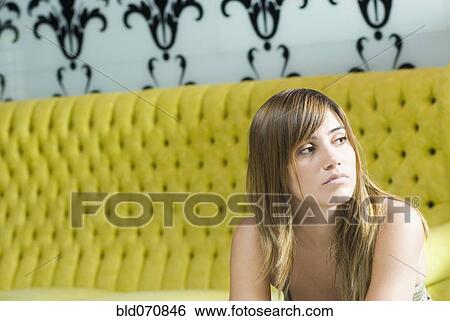Hispanic woman sitting on retro sofa View Large Photo Image Stock Photograph - Hispanic woman sitting on retro sofa. Fotosearch