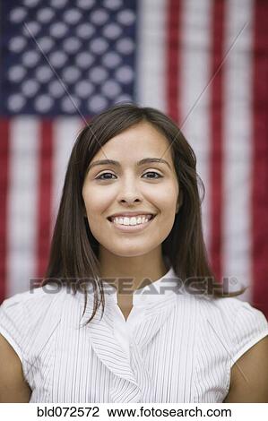 Hispanic woman standing near American flag View Large Photo Image Stock Image - Hispanic woman standing near American flag. Fotosearch