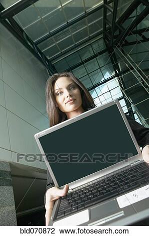 Stock Image - Italian businesswoman holding laptop. Fotosearch