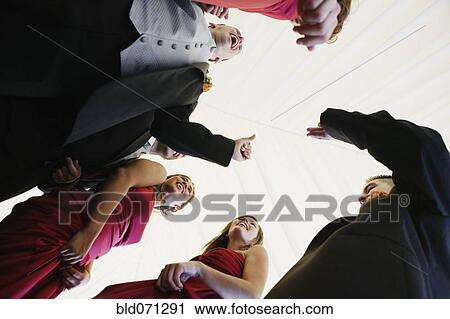 Stock Image - Low angle view of multi-ethnic bridal party. Fotosearch