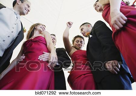 Stock Image - Low angle view of multi-ethnic bridal party. Fotosearch