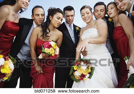 Stock Photo - Low angle view of multi-ethnic bridal party. Fotosearch