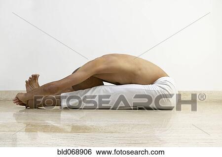 Man stretching indoors View Large Photo Image Stock Photograph - Man stretching indoors. Fotosearch